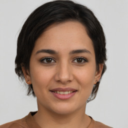 Joyful white young-adult female with medium  brown hair and brown eyes