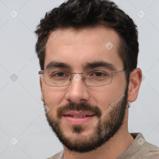 Joyful white young-adult male with short  black hair and brown eyes