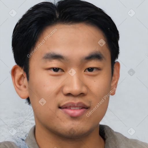 Joyful asian young-adult male with short  black hair and brown eyes