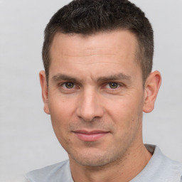 Joyful white adult male with short  brown hair and brown eyes