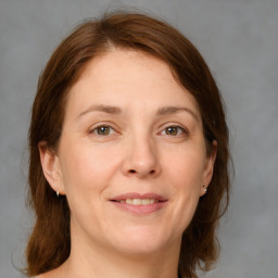 Joyful white adult female with medium  brown hair and grey eyes