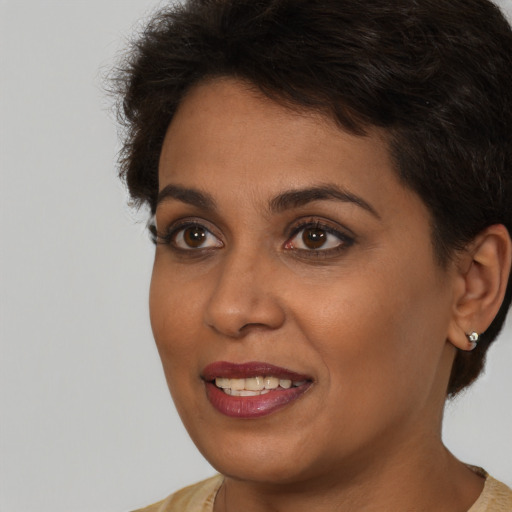 Joyful latino young-adult female with short  brown hair and brown eyes