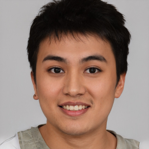 Joyful asian young-adult male with short  brown hair and brown eyes