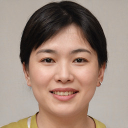 Joyful asian young-adult female with short  brown hair and brown eyes