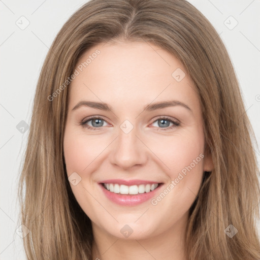 Joyful white young-adult female with long  brown hair and green eyes