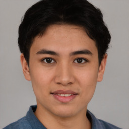 Joyful asian young-adult male with short  black hair and brown eyes