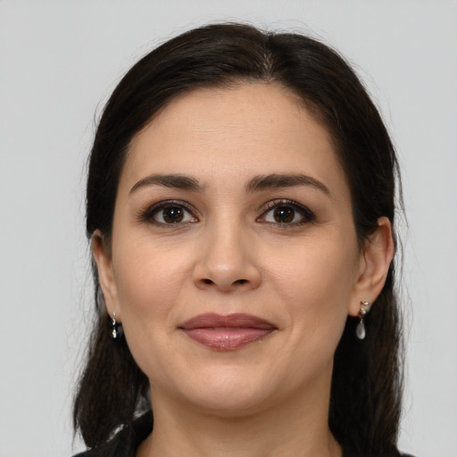 Joyful white young-adult female with medium  brown hair and brown eyes