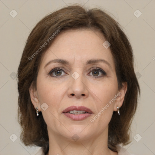 Joyful white adult female with medium  brown hair and grey eyes