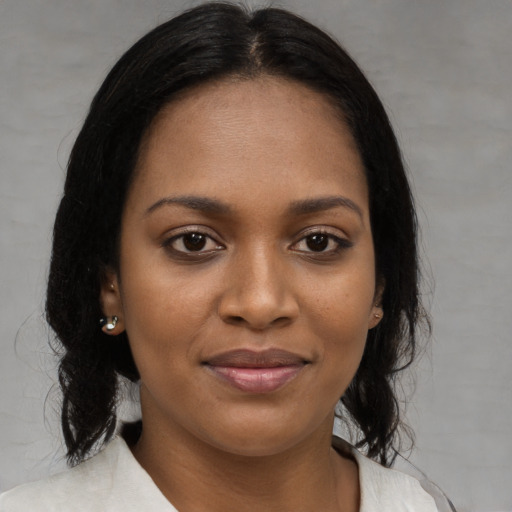 Joyful black young-adult female with medium  brown hair and brown eyes