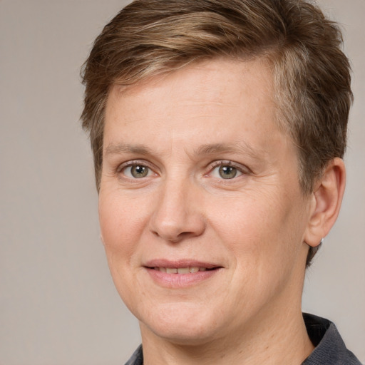 Joyful white adult female with short  brown hair and grey eyes