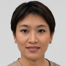 Joyful asian young-adult female with short  brown hair and brown eyes