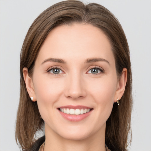 Joyful white young-adult female with long  brown hair and grey eyes