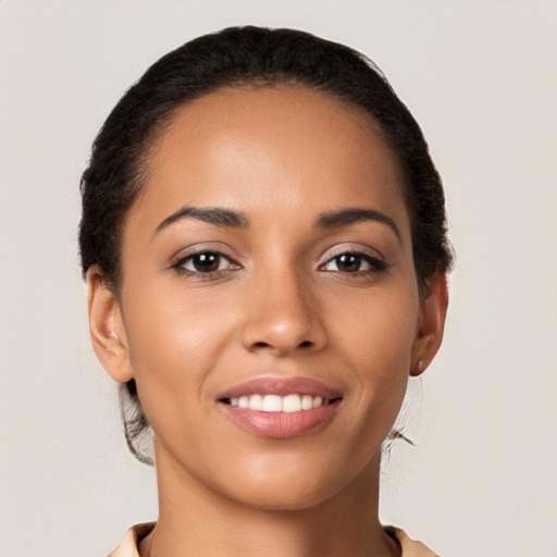 Joyful latino young-adult female with short  brown hair and brown eyes