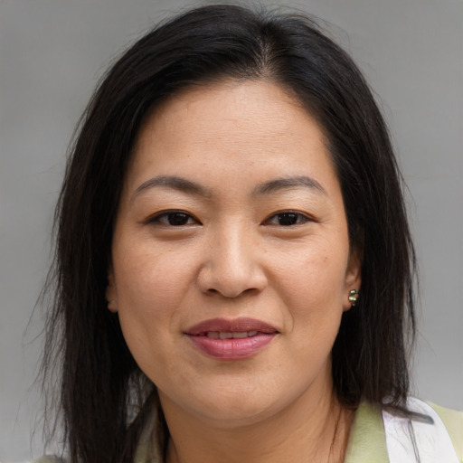 Joyful asian adult female with medium  brown hair and brown eyes
