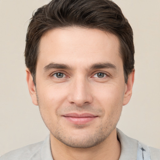 Joyful white young-adult male with short  brown hair and brown eyes