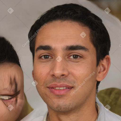 Joyful white young-adult male with short  black hair and brown eyes