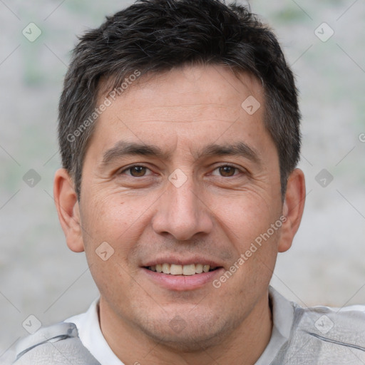 Joyful white adult male with short  brown hair and brown eyes