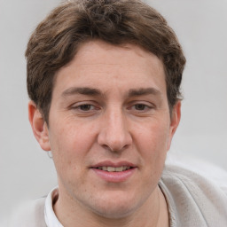 Joyful white adult male with short  brown hair and grey eyes