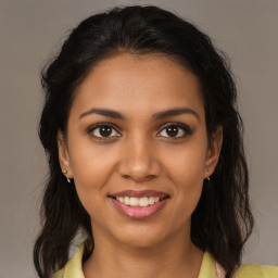 Joyful black young-adult female with medium  brown hair and brown eyes