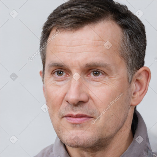 Joyful white adult male with short  brown hair and brown eyes