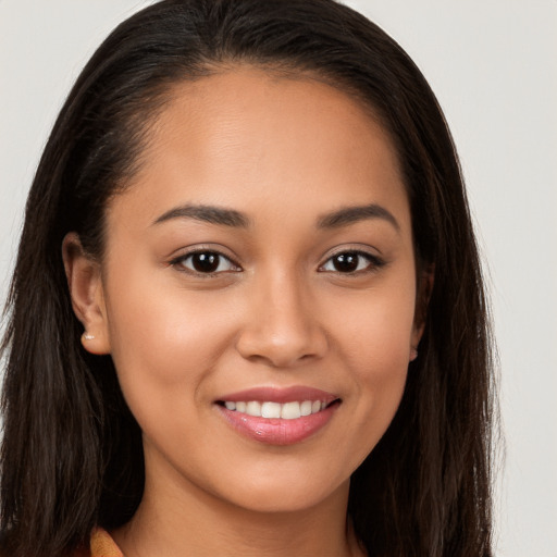 Joyful white young-adult female with long  brown hair and brown eyes