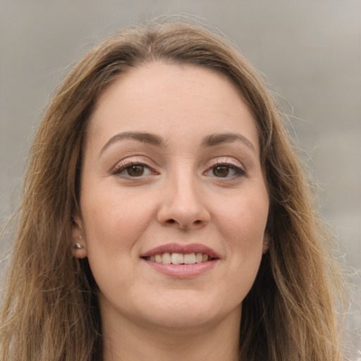 Joyful white young-adult female with long  brown hair and grey eyes