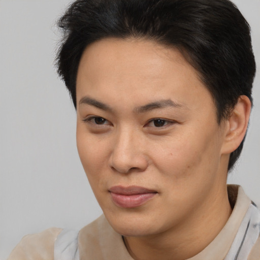 Joyful asian young-adult female with short  brown hair and brown eyes