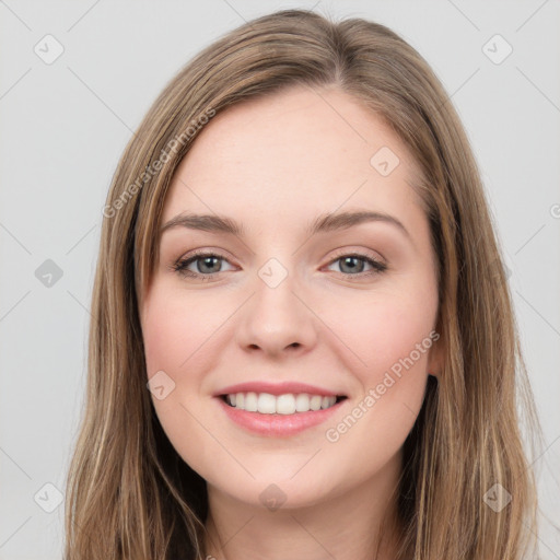 Joyful white young-adult female with long  brown hair and green eyes