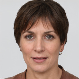 Joyful white adult female with short  brown hair and grey eyes