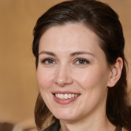 Joyful white adult female with medium  brown hair and brown eyes