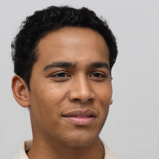 Joyful latino young-adult male with short  brown hair and brown eyes