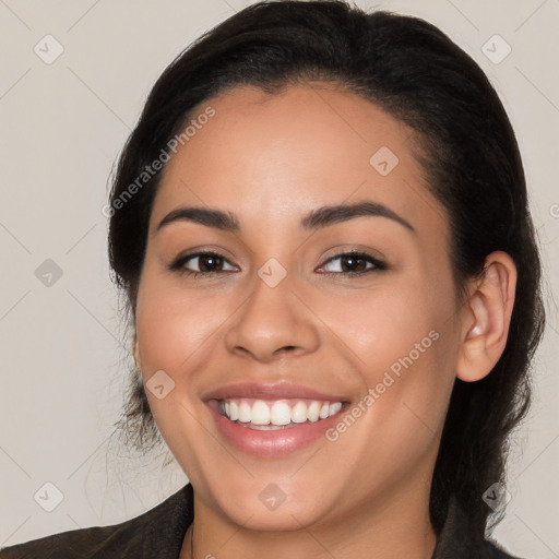 Joyful latino young-adult female with long  brown hair and brown eyes