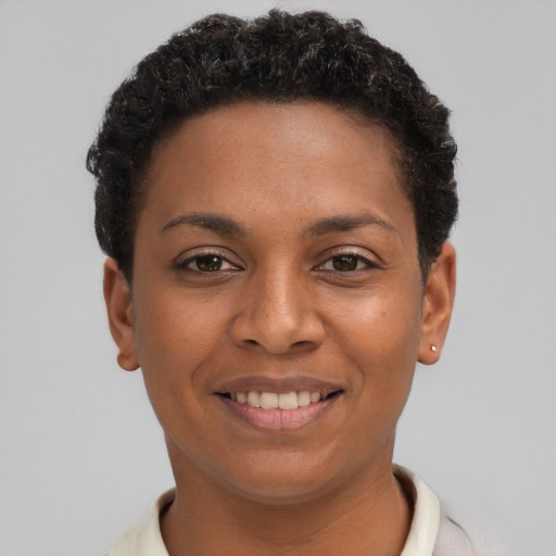 Joyful black young-adult female with short  black hair and brown eyes