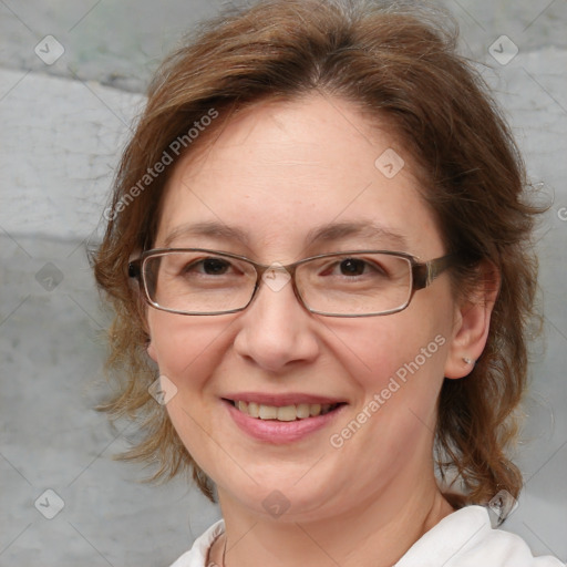 Joyful white adult female with medium  brown hair and blue eyes