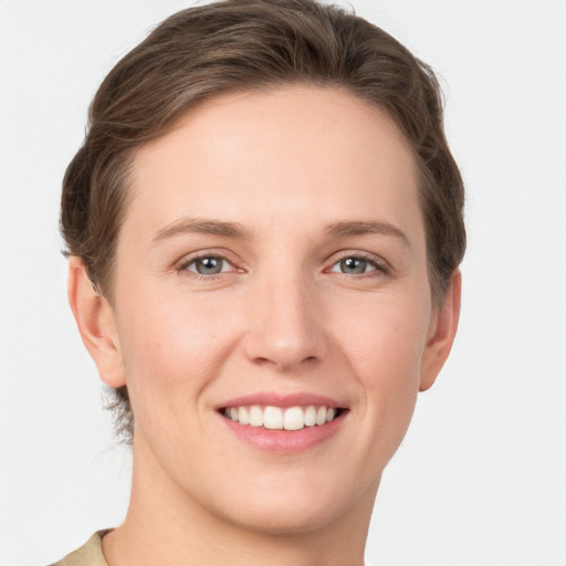 Joyful white young-adult female with short  brown hair and grey eyes