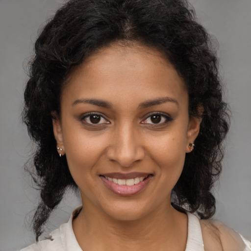 Joyful black young-adult female with medium  brown hair and brown eyes