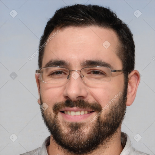 Joyful white adult male with short  black hair and brown eyes