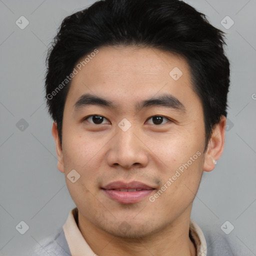 Joyful asian young-adult male with short  black hair and brown eyes