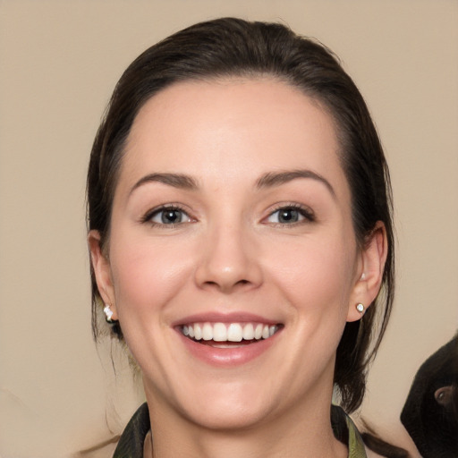 Joyful white young-adult female with long  brown hair and brown eyes