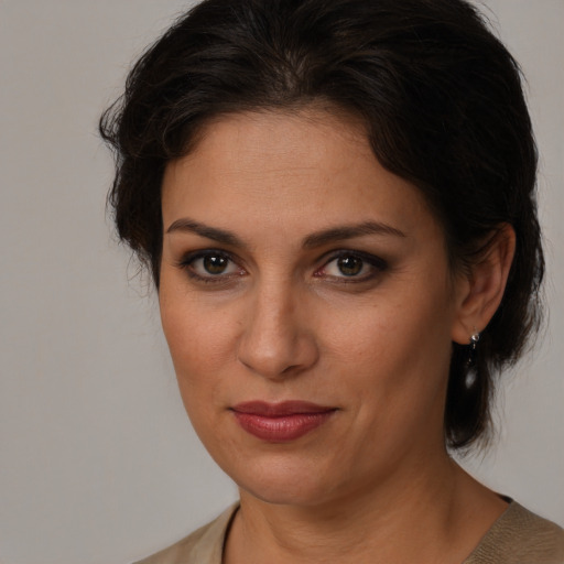 Joyful white adult female with medium  brown hair and brown eyes