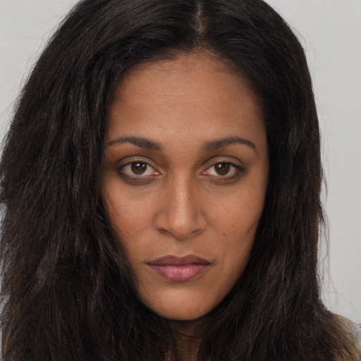 Neutral black young-adult female with long  brown hair and brown eyes