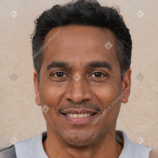 Joyful latino adult male with short  black hair and brown eyes