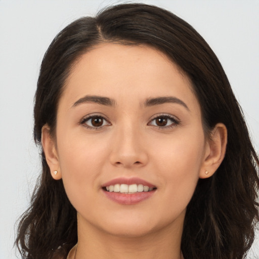 Joyful white young-adult female with long  brown hair and brown eyes