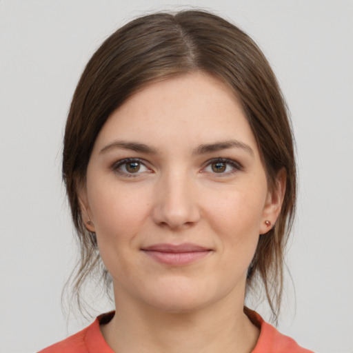 Joyful white young-adult female with medium  brown hair and grey eyes