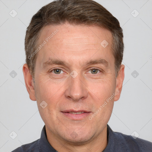 Joyful white adult male with short  brown hair and grey eyes