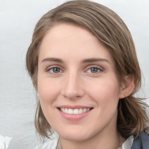 Joyful white young-adult female with medium  brown hair and blue eyes