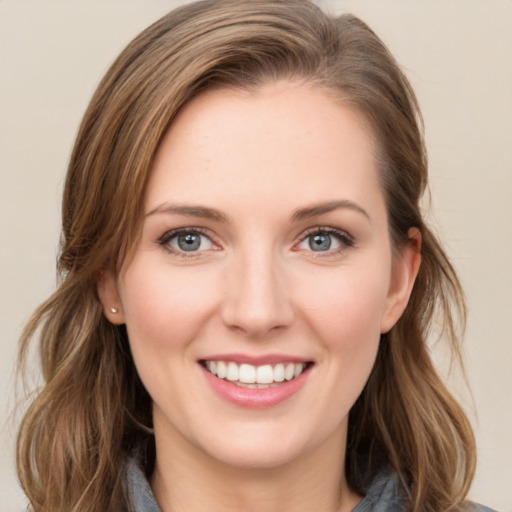 Joyful white young-adult female with medium  brown hair and green eyes