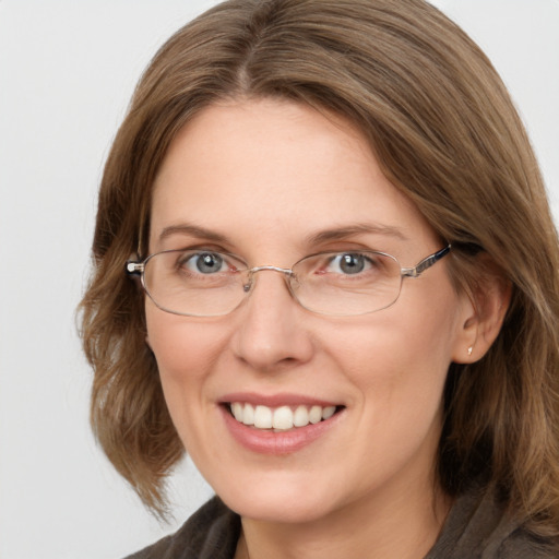 Joyful white adult female with medium  brown hair and blue eyes