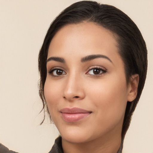 Joyful latino young-adult female with medium  brown hair and brown eyes