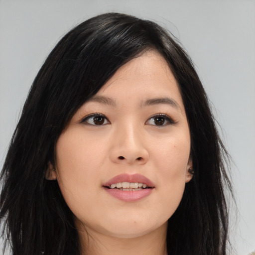 Joyful asian young-adult female with long  black hair and brown eyes